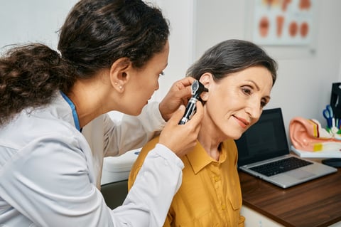 Hearing exam for elderly patient at medical clinic