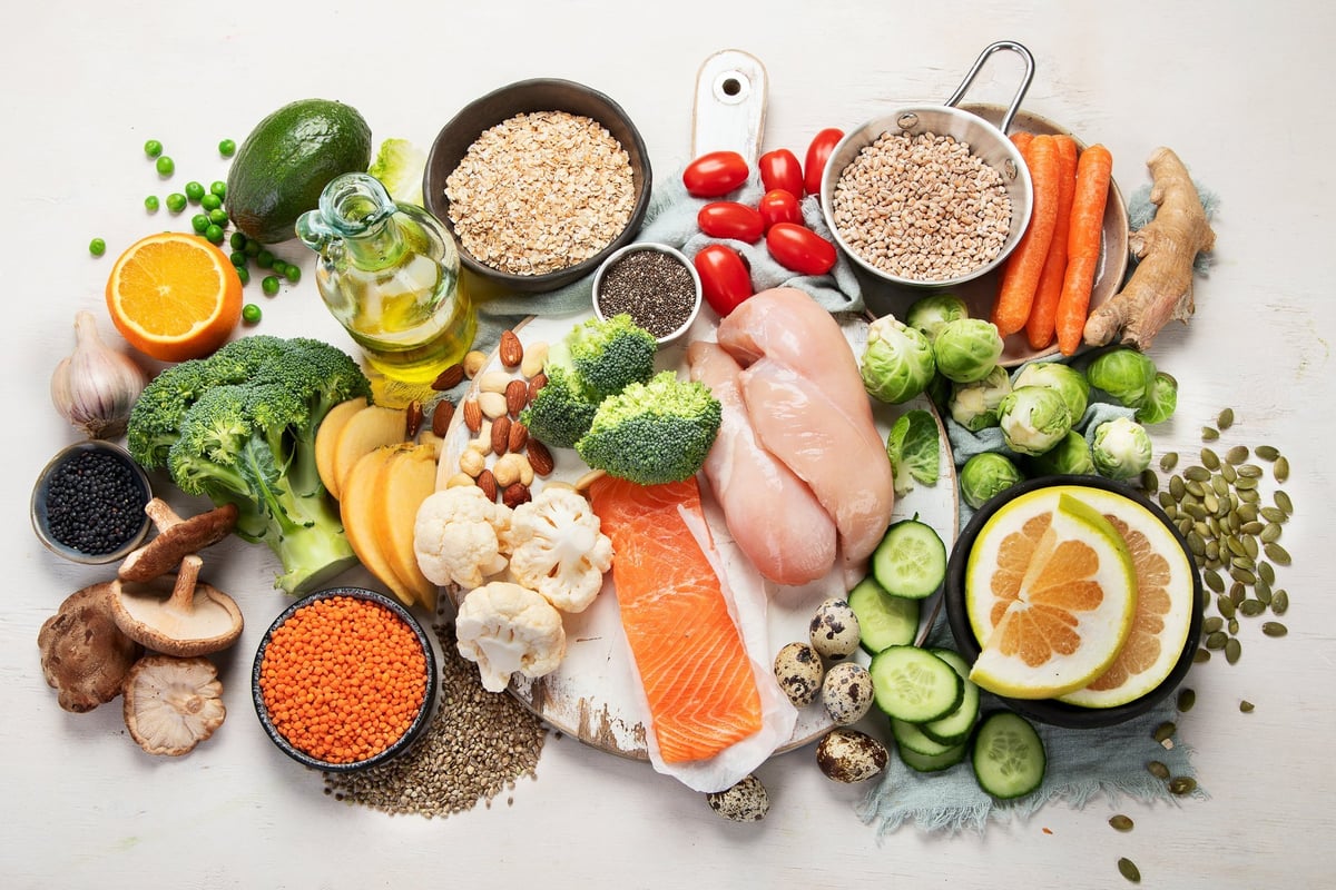 Healthy food selection including salmon, vegetables, fruits, nuts and supplements supporting hearing health