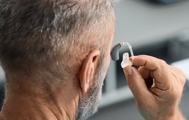 Senior man with hearing aid during doctor visit